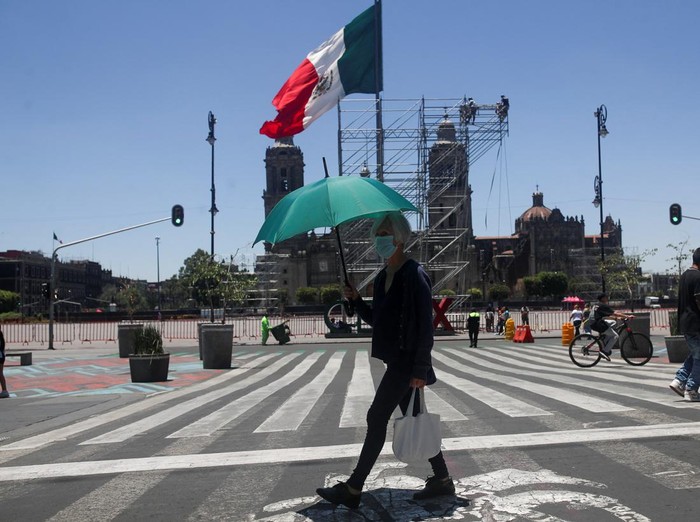 A woman holds an umbrella during a period of high temperatures in Mexico City, Mexico June 13, 2023. REUTERS/Henry Romero