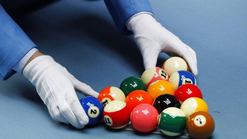 A game official racks the balls during a womens 8 ball pool singles match between South Koreas Cha You-ram and Thailands Chonticha Chitchonmart at the 16th Asian Games in Guangzhou, China, Wednesday, Nov. 17, 2010. (AP Photo/Dita Alangkara)
