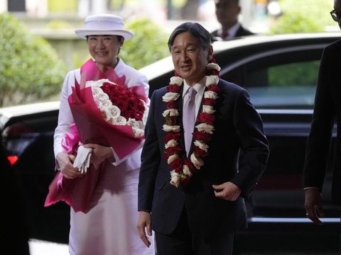 Japan's Emperor Naruhito, right, and Empress Masako walk on the red carpet upon arrival at their hotel in Jakarta, Indonesia, Saturday, June 17, 2023. The Japanese royals are on a weeklong visit in the country, their first official friendship trip abroad since ascending the Chrysanthemum Throne four years ago. (AP Photo/Dita Alangkara, Pool)