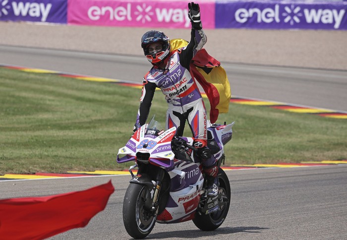 Spains Jorge Martin, of the Prima Pramac Racing team, rides his bike as he celebrates after winning the German Grand Prix, at the Sachsenring racing circuit, in Hohenstein-Ernstthal, Germany, Sunday, June 18, 2023. (Jan Woitas/dpa via AP)