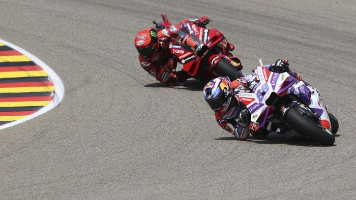 Spains Jorge Martin, of the Prima Pramac Racing team, rides his bike as he celebrates after winning the German Grand Prix, at the Sachsenring racing circuit, in Hohenstein-Ernstthal, Germany, Sunday, June 18, 2023. (Jan Woitas/dpa via AP)