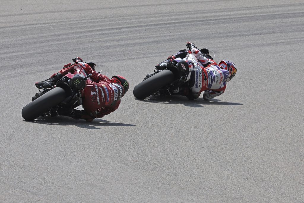 Spain's Jorge Martin, of the Prima Pramac Racing team, right, rides his bike ahead of Italy's Francesco Bagnaia, of the Ducati Lenovo team, during the German Grand Prix, at the Sachsenring racing circuit, in Hohenstein-Ernstthal, Germany, Sunday, June 18, 2023. (Jan Woitas/dpa via AP)