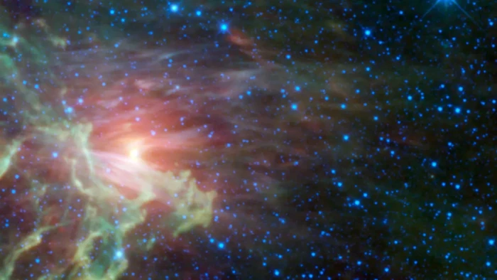 Bintang merah melesat dan membara saat keluar dari sistem gugus bintangnya di nebula Flaming Star nebula (NASA/JPL-Caltech/UCLA)