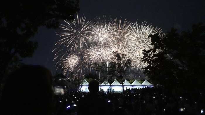 Firework explode over the Han River during an event to celebrate the 10th debut anniversary of K-pop band BTS in Seoul, South Korea, Saturday, June 17, 2023. (AP Photo/Lee Jin-man)