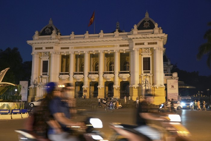 Drivers and motorcyclists move through a street during a blackout in Hanoi, Vietnam, on June 8, 2023. Vietnam has released a long-anticipated energy plan meant to take the country through the next decade and help meet soaring demand while reducing carbon emissions. (AP Photo/Hau Dinh)