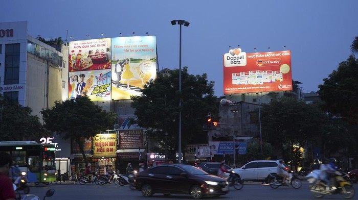 Drivers and motorcyclists move through a street during a blackout in Hanoi, Vietnam, on June 8, 2023. Vietnam has released a long-anticipated energy plan meant to take the country through the next decade and help meet soaring demand while reducing carbon emissions. (AP Photo/Hau Dinh)
