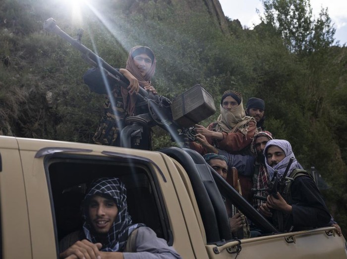 A unit of Taliban fighters ride in a pickup truck on a road in Wardak province, Afghanistan, Sunday, June 18, 2023. (AP Photo/Rodrigo Abd)