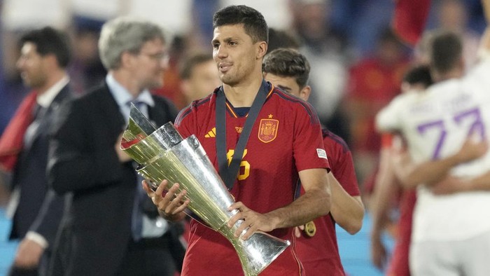 Spains Rodri holds the trophy after winning the Nations League final soccer match between Croatia and Spain at De Kuip stadium in Rotterdam, Netherlands, Sunday, June 18, 2023. Spain won 5-4 in a penalty shootout after the match ended tied 0-0. (AP Photo/Peter Dejong)