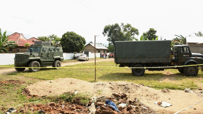 Locals gather at the cordoned scene outside the Mpondwe Lhubirira Secondary School, after militants linked to rebel group Allied Democratic Forces (ADF) killed and abducted multiple people, in Mpondwe, western Uganda, June 17, 2023. REUTERS/Stringer REFILE - QUALITY REPEAT