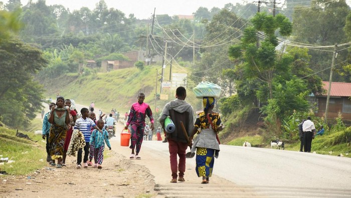 Locals gather at the cordoned scene outside the Mpondwe Lhubirira Secondary School, after militants linked to rebel group Allied Democratic Forces (ADF) killed and abducted multiple people, in Mpondwe, western Uganda, June 17, 2023. REUTERS/Stringer REFILE - QUALITY REPEAT