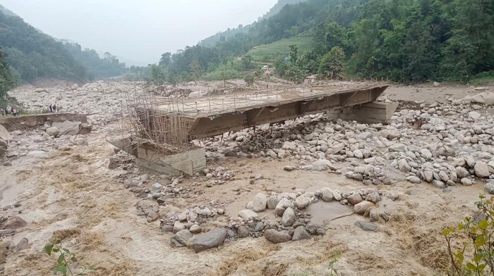People stand near a site of a landslide caused due to heavy rains in Sankhuwasabha, Nepal, June 18, 2023 in this screen grab obtained from a social media video. Roman Gurung/via REUTERS  THIS IMAGE HAS BEEN SUPPLIED BY A THIRD PARTY. MANDATORY CREDIT. NO RESALES. NO ARCHIVES.