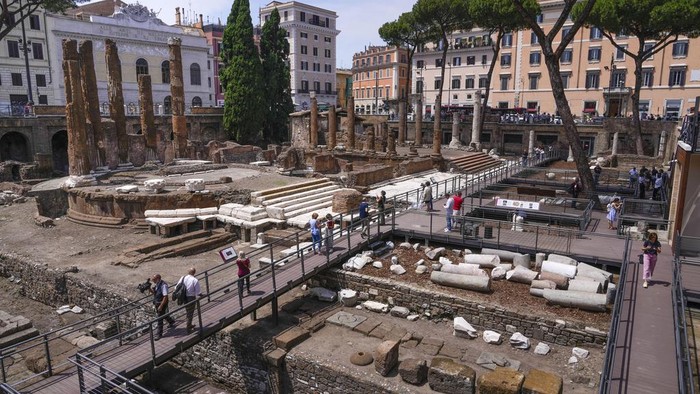 Journalists visit the new walkways of the so called 'Sacred Area' where four temples, dating back as far as the 3rd century B.C., stand smack in the middle of one of modern Rome's busiest crossroads, Monday, June 19, 2023, With the help of funding from Bulgari, the luxury jeweler, the grouping of temples can now be visited by the public that for decades had to gaze down from the bustling sidewalks rimming Largo Argentina (Argentina Square) to admire the temples below where Julius Caesar masterminded his political strategies and was later fatally stabbed in 44 B.C. (AP Photo/Domenico Stinellis)