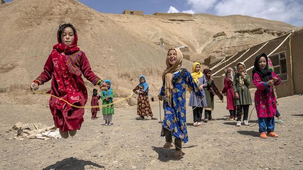 School girls play in the grounds of a rural school in Bamiyan, Afghanistan, Sunday, June 18, 2023. (AP Photo/Ebrahim Noroozi)