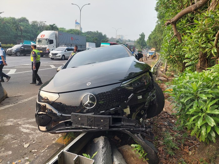 Kecelakaan mobil Mercy listrik terjadi di ruas Tol JORR dekat GT Ciputat 2. Mobil sedan hitam tersebut menabrak pembatas jalan hingga bagian bumper depan rusak.