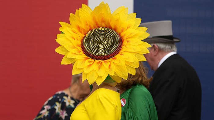 A racegoer wears a hat with a brim comprised of figures of horses as she arrives for day one of the Royal Ascot horse racing meeting, at Ascot Racecourse in Ascot, England, Tuesday, June 20, 2023.(AP Photo/Alastair Grant)