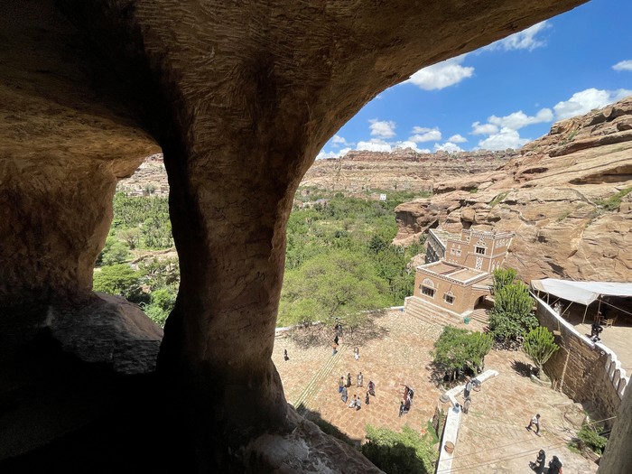 People walk at the yard of Dar al-Hajar, or the Rock Palace, built in the 1930s and become a popular attraction for visitors for its architectural and historical significance, on the outskirts of Sanaa, Yemen, May 26, 2023. REUTERS/Khaled Abdullah