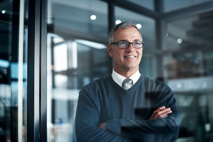 Shot of a mature businessman looking thoughtful while working late in an office
