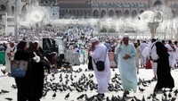 Kipas angin yang menyemprotkan air ke jemaah untuk melembabkan udara terlihat saat orang-orang mulai berdatangan untuk menunaikan umrah di Kabah. 