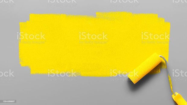 Colors of the year 2021 Ultimate Gray and Illuminating Yellow. Paint roller painting a yellow stripe on a gray background. Minimalistic composition with copy space