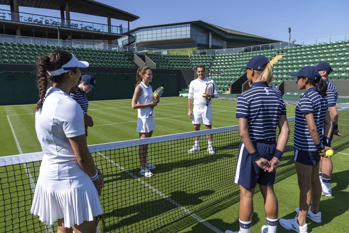 In this undated photo released by Kensington Palace on Saturday, June 24, 2023, Britains Kate, Princess of Wales and eight-time Wimbledon champion Roger Federer in action, at the AELTC Indoor Tennis Courts, during a visit to the All England Lawn Tennis Club in Wimbledon, England for a behind-the-scenes look at work of the ball boys and girls who are a key part of the tennis tournament. (Thomas Lovelock/AELTC via AP)