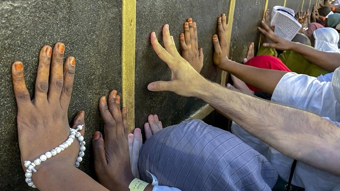 Muslim pilgrims pray in front of the Kaaba, the cubic building at the Grand Mosque, during the annual hajj pilgrimage, in Mecca, Saudi Arabia, Sunday, June 25, 2023. Muslim pilgrims are converging on Saudi Arabia's holy city of Mecca for the largest hajj since the coronavirus pandemic severely curtailed access to one of Islam's five pillars. (AP Photo/Amr Nabil)