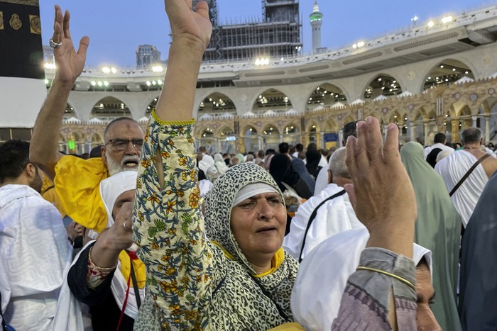 Muslim pilgrims pray in front of the Kaaba, the cubic building at the Grand Mosque, during the annual hajj pilgrimage, in Mecca, Saudi Arabia, Sunday, June 25, 2023. Muslim pilgrims are converging on Saudi Arabias holy city of Mecca for the largest hajj since the coronavirus pandemic severely curtailed access to one of Islams five pillars. (AP Photo/Amr Nabil)