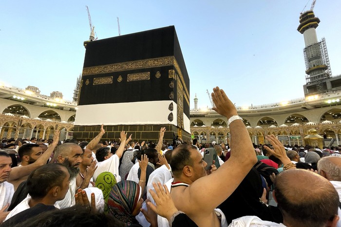 Thousands of Muslim pilgrims hold umbrellas as they circumambulate around the Kaaba, the cubic building at the Grand Mosque, during the annual hajj pilgrimage, in Mecca, Saudi Arabia, Sunday, June 25, 2023. Muslim pilgrims are converging on Saudi Arabias holy city of Mecca for the largest Hajj since the coronavirus pandemic severely curtailed access to one of Islams five pillars. (AP Photo/Amr Nabil)