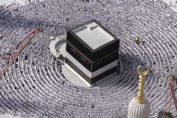 Thousands of Muslim pilgrims hold umbrellas as they circumambulate around the Kaaba, the cubic building at the Grand Mosque, during the annual hajj pilgrimage, in Mecca, Saudi Arabia, Sunday, June 25, 2023. Muslim pilgrims are converging on Saudi Arabias holy city of Mecca for the largest Hajj since the coronavirus pandemic severely curtailed access to one of Islams five pillars. (AP Photo/Amr Nabil)