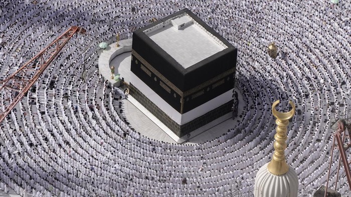 Thousands of Muslim pilgrims hold umbrellas as they circumambulate around the Kaaba, the cubic building at the Grand Mosque, during the annual hajj pilgrimage, in Mecca, Saudi Arabia, Sunday, June 25, 2023. Muslim pilgrims are converging on Saudi Arabias holy city of Mecca for the largest Hajj since the coronavirus pandemic severely curtailed access to one of Islams five pillars. (AP Photo/Amr Nabil)