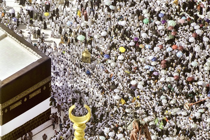 Thousands of Muslim pilgrims hold umbrellas as they circumambulate around the Kaaba, the cubic building at the Grand Mosque, during the annual hajj pilgrimage, in Mecca, Saudi Arabia, Sunday, June 25, 2023. Muslim pilgrims are converging on Saudi Arabias holy city of Mecca for the largest Hajj since the coronavirus pandemic severely curtailed access to one of Islams five pillars. (AP Photo/Amr Nabil)
