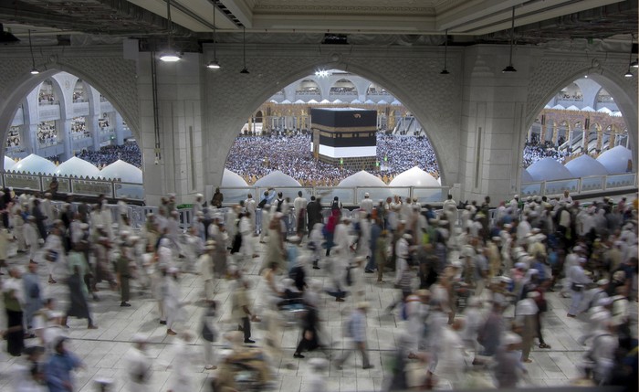 Thousands of Muslim pilgrims hold umbrellas as they circumambulate around the Kaaba, the cubic building at the Grand Mosque, during the annual hajj pilgrimage, in Mecca, Saudi Arabia, Sunday, June 25, 2023. Muslim pilgrims are converging on Saudi Arabias holy city of Mecca for the largest Hajj since the coronavirus pandemic severely curtailed access to one of Islams five pillars. (AP Photo/Amr Nabil)