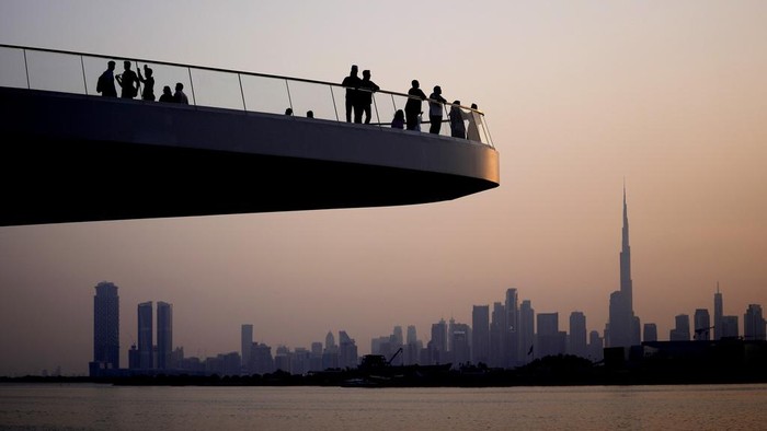 People stand on the observation deck of the Dubai Creek Harbour in Dubai, United Arab Emirates, Sunday, June 18, 2023, to view the city skyline with the worlds tallest tower, the Burj Khalifa. (AP Photo/Kamran Jebreili)