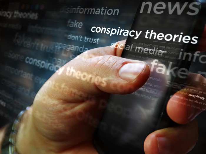 Social media on display with Conspiracy theories, hoax theory and fake news. Searching on tablet, pad, phone or smartphone screen in hand. Abstract concept of news titles 3d illustration.