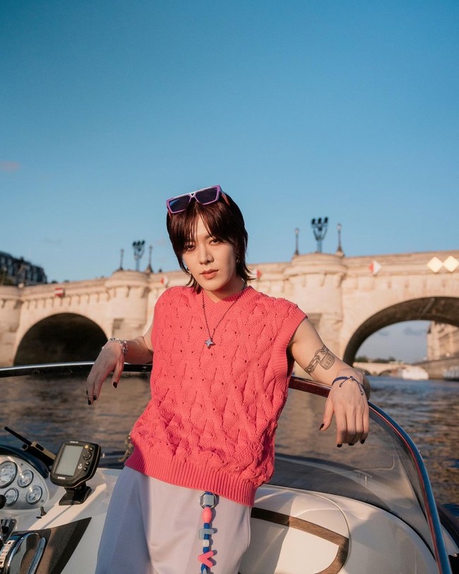Yuta NCT memakai busana colorful dengan atasan vest berwarna pink dan celana berwarna lilac. Gayanya semakin edgy dengan tambahan kacamata di atas kepalanya. Foto: Instagram