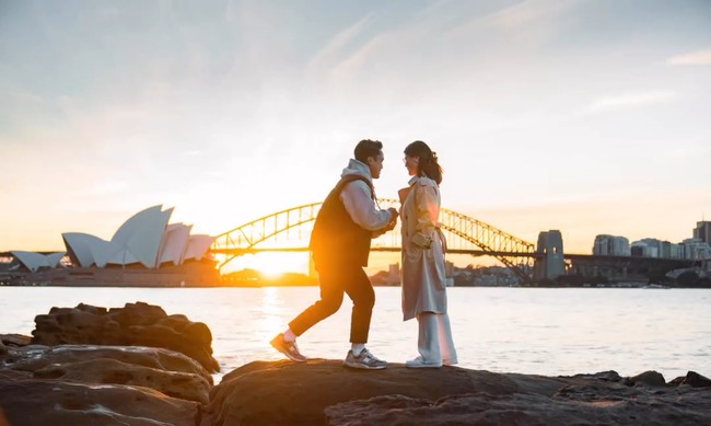 Keduanya terlihat berdiri di atas bebatuan, di depan pemandangan Opera House dan Jembatan Sydney Harbour. Foto: Instagram/@sinisukanthony