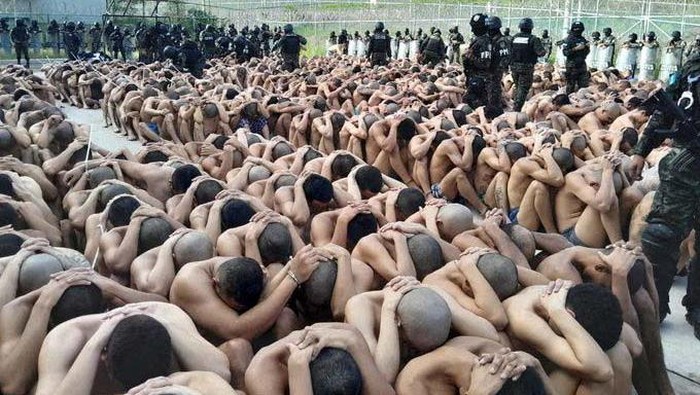 Members of the Military Police of Public Order guard gang members after the Honduras Armed Forces took over the control of the prisons nationwide as part of the 
