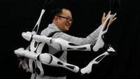 Masahiko Inami of the University of Tokyo poses with the wearable Jizai Arms robot arms at his lab during its demonstration in Tokyo, Japan, June 22, 2023. REUTERS/Kim Kyung-Hoon