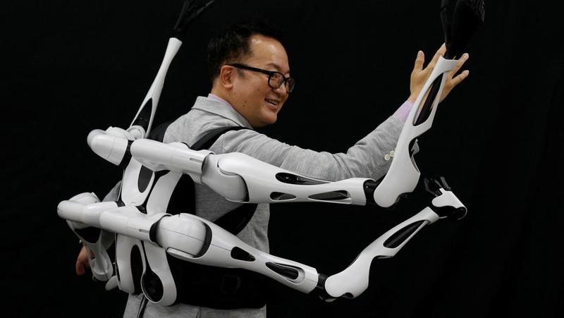 Masahiko Inami of the University of Tokyo poses with the wearable 