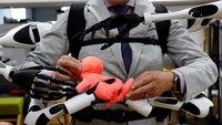 Masahiko Inami of the University of Tokyo poses with the wearable Jizai Arms robot arms at his lab during its demonstration in Tokyo, Japan, June 22, 2023. REUTERS/Kim Kyung-Hoon