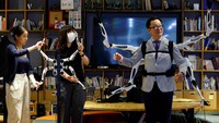 Masahiko Inami of the University of Tokyo poses with the wearable Jizai Arms robot arms at his lab during its demonstration in Tokyo, Japan, June 22, 2023. REUTERS/Kim Kyung-Hoon