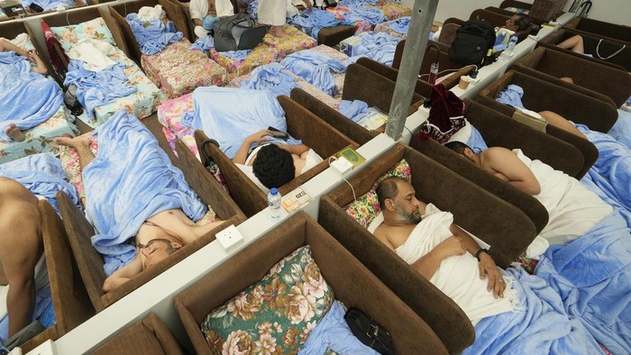 Muslim pilgrims rest at the Mina tent camp, in Mecca, Saudi Arabia, during the annual hajj pilgrimage, Monday, June 26, 2023. Muslim pilgrims are converging on Saudi Arabia's holy city of Mecca for the largest hajj since the coronavirus pandemic severely curtailed access to one of Islam's five pillars. (AP Photo/Amr Nabil)