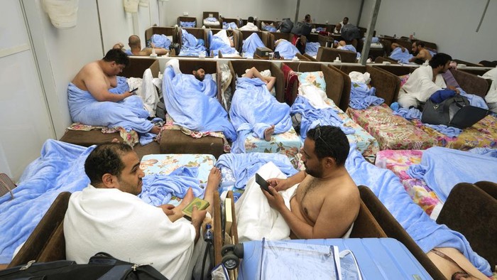 Muslim pilgrims rest at the Mina tent camp, in Mecca, Saudi Arabia, during the annual hajj pilgrimage, Monday, June 26, 2023. Muslim pilgrims are converging on Saudi Arabia's holy city of Mecca for the largest hajj since the coronavirus pandemic severely curtailed access to one of Islam's five pillars. (AP Photo/Amr Nabil)