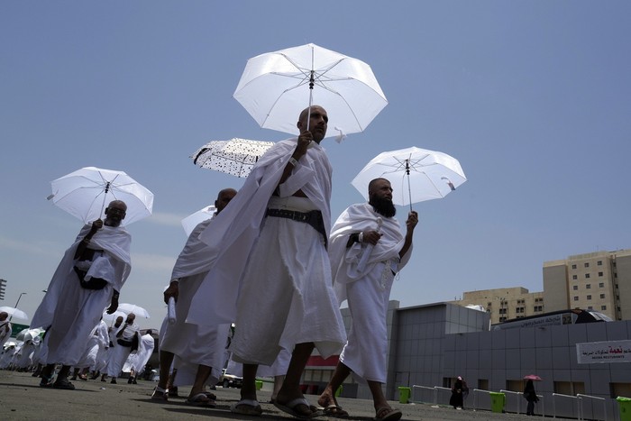 Muslim pilgrims walk, holding their umbrellas at the Mina tent camp, in Mecca, Saudi Arabia, during the annual hajj pilgrimage, Monday, June 26, 2023. Muslim pilgrims are converging on Saudi Arabias holy city of Mecca for the largest hajj since the coronavirus pandemic severely curtailed access to one of Islams five pillars. (AP Photo/Amr Nabil)