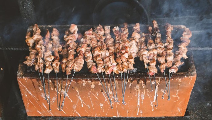 Sate Klatak grilling on charcoal grill. Sate klathak is a unique goat satay or mutton satay dish, originally from Yogyakarta, Indonesia.