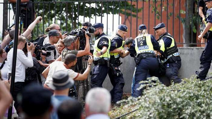 Police officers intervene after peoples reaction as demonstrators burn the Koran (not pictured) outside Stockholms central mosque in Stockholm, Sweden June 28, 2023. TT News Agency/Caisa Rasmussen/via REUTERS      ATTENTION EDITORS - THIS IMAGE WAS PROVIDED BY A THIRD PARTY. SWEDEN OUT. NO COMMERCIAL OR EDITORIAL SALES IN SWEDEN.