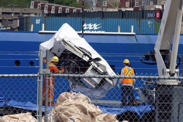 Debris from the Titan submersible, recovered from the ocean floor near the wreck of the Titanic, is unloaded from the ship Horizon Arctic at the Canadian Coast Guard pier in St. Johns, Newfoundland, Wednesday, June 28, 2023. (Paul Daly/The Canadian Press via AP)