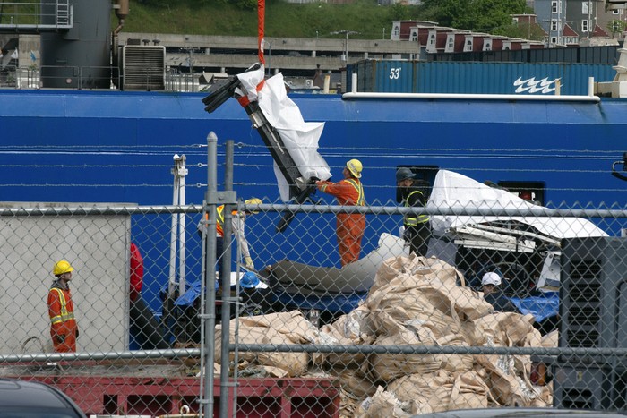 Debris from the Titan submersible, recovered from the ocean floor near the wreck of the Titanic, is unloaded from the ship Horizon Arctic at the Canadian Coast Guard pier in St. Johns, Newfoundland, Wednesday, June 28, 2023. (Paul Daly/The Canadian Press via AP)