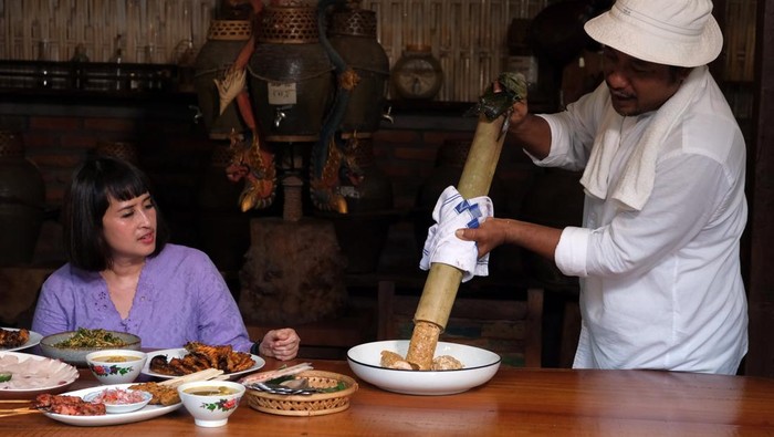 Sensasi Kuliner di βDapur Tradisionalβ Bali Koki menyajikan ikan timbungan atau hidangan tradisional khas Bali kepada wisatawan di Dapur Bali Mula, Desa Les Tejakula, Buleleng, Bali, Kamis (29/6/2023). Warung kuliner yang mengusung konsep dapur tradisional Bali tersebut menjadi daya tarik bagi wisatawan untuk berkunjung dan menerapkan sistem pembayaran secara sukarela. ANTARA FOTO/Nyoman Hendra Wibowo/hp.