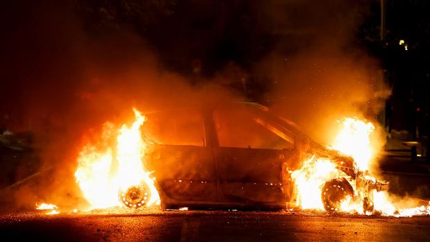 A vehicle burns during clashes between protesters and police, following the death of Nahel, a 17-year-old teenager killed by a French police officer during a traffic stop, in Nanterre, Paris suburb, France, June 29, 2023. REUTERS/Gonzalo Fuentes