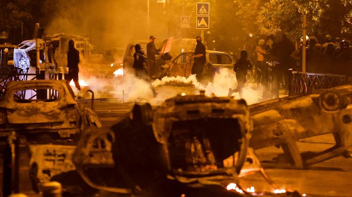 French police stand in position as fireworks go off during clashes with youth, after the death of Nahel, a 17-year-old teenager killed by a French police officer during a traffic stop, in Nanterre, Paris suburb, France, June 30, 2023. REUTERS/Gonzalo Fuentes     TPX IMAGES OF THE DAY